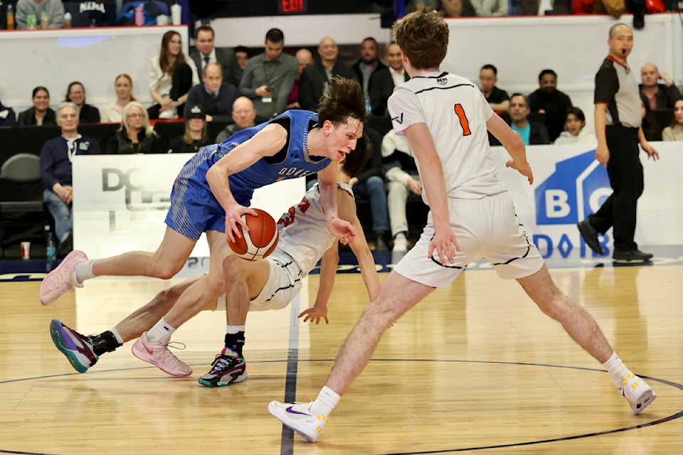 Dover Bay Dolphins player Frank Linder competes against Spectrum Thunder opponents in the senior AAAA boys' basketball provincial championship game Saturday, March 8, at the Langley Events Centre. (Ryan Molag/Langley Events Centre)