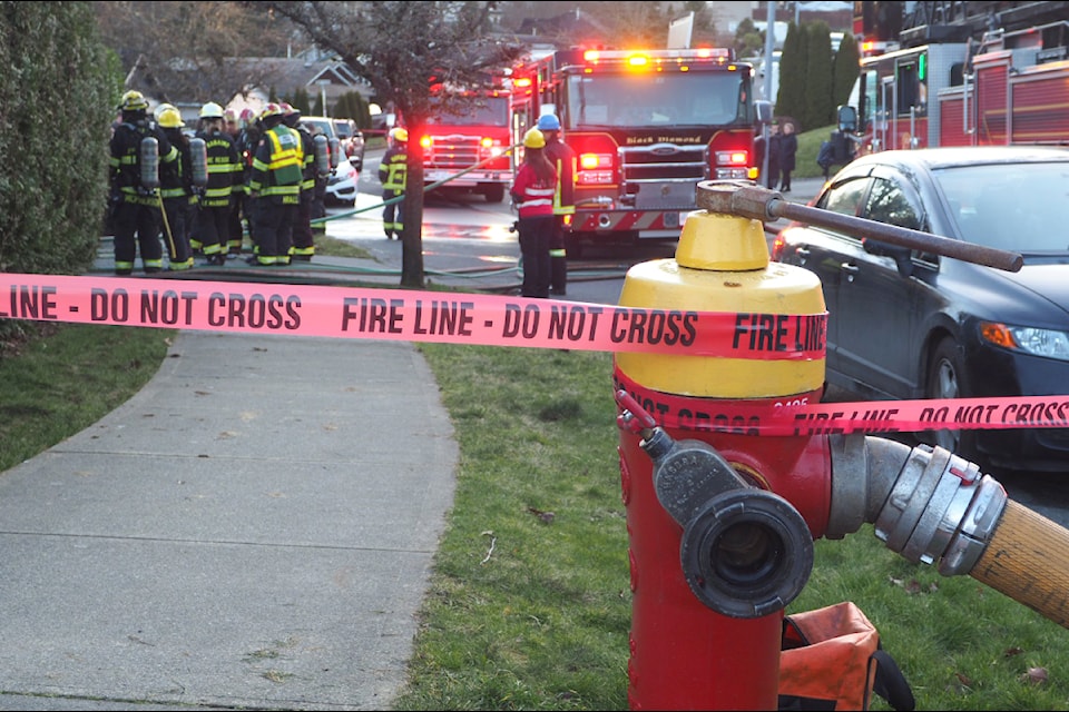 Firefighters extinguish a house fire on Ranchview Drive in Nanaimo's Extension area on Monday, Jan. 27. (Chris Bush/News Bulletin)