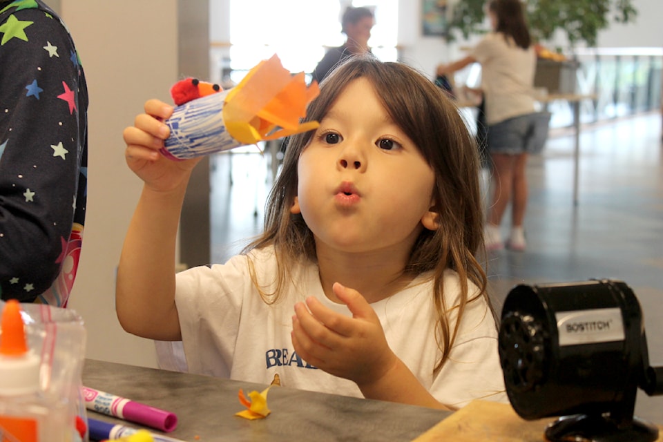 Mia Huang shows off the fire-breathing dragon she made at Harbourfront Library's Namblebrary Academy of Elemental Magic on Friday, July 25. (Jessica Durling/News Bulletin)