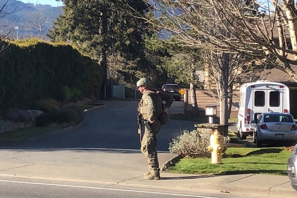 An armed officer walks outside Cerwydden Care on Cowichan Lake Road near Skinner Road Wednesday, April 14 around 5:30 p.m. (Kevin Rothbauer/Citizen)