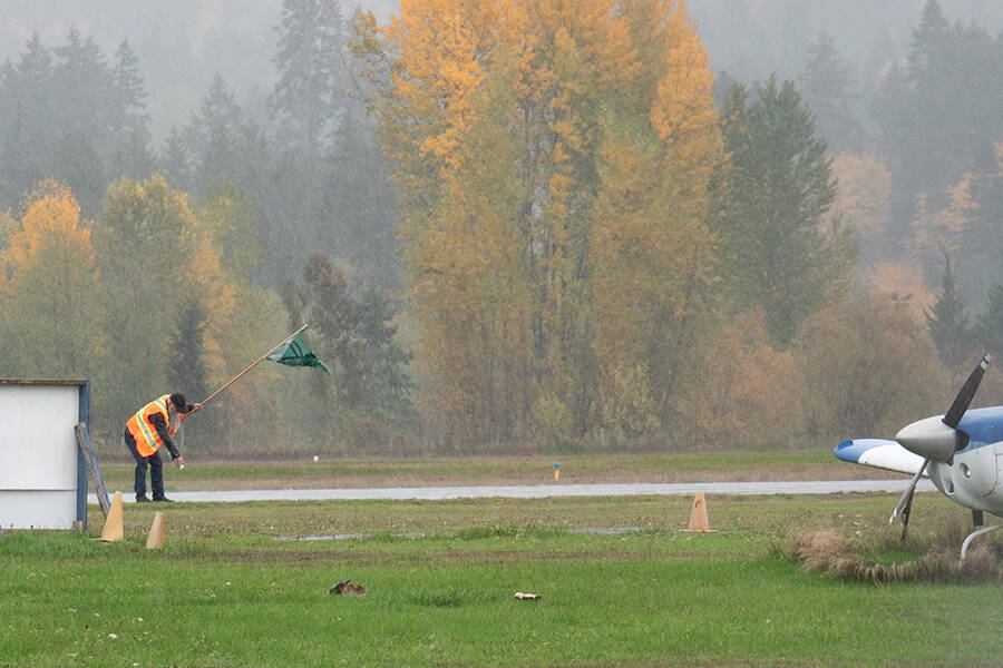 A man walks on the Nanaimo Airport tarmac on Oct. 25 as part of Extinction Rebellion protest. (Photo by Tyler Hay)