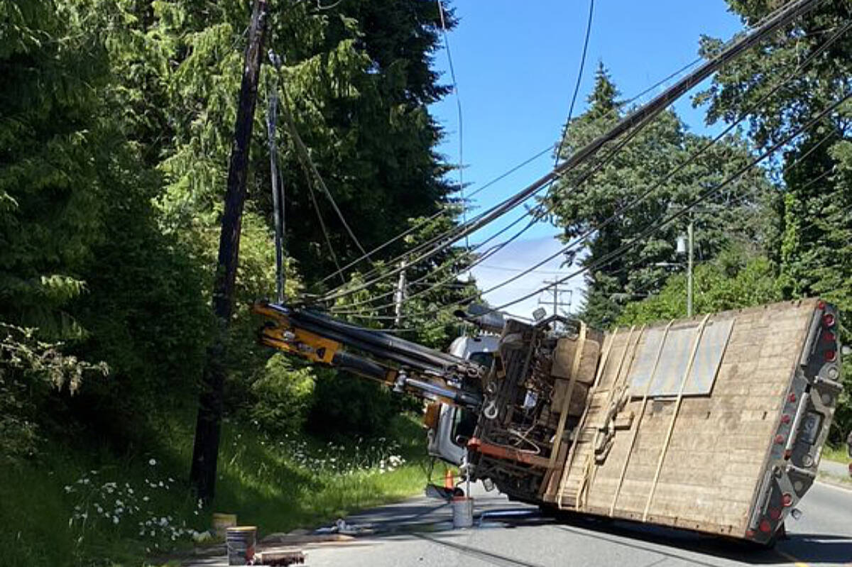 29555639_web1_220623-NBU-Crane-truck-catches-wires-flips-_2