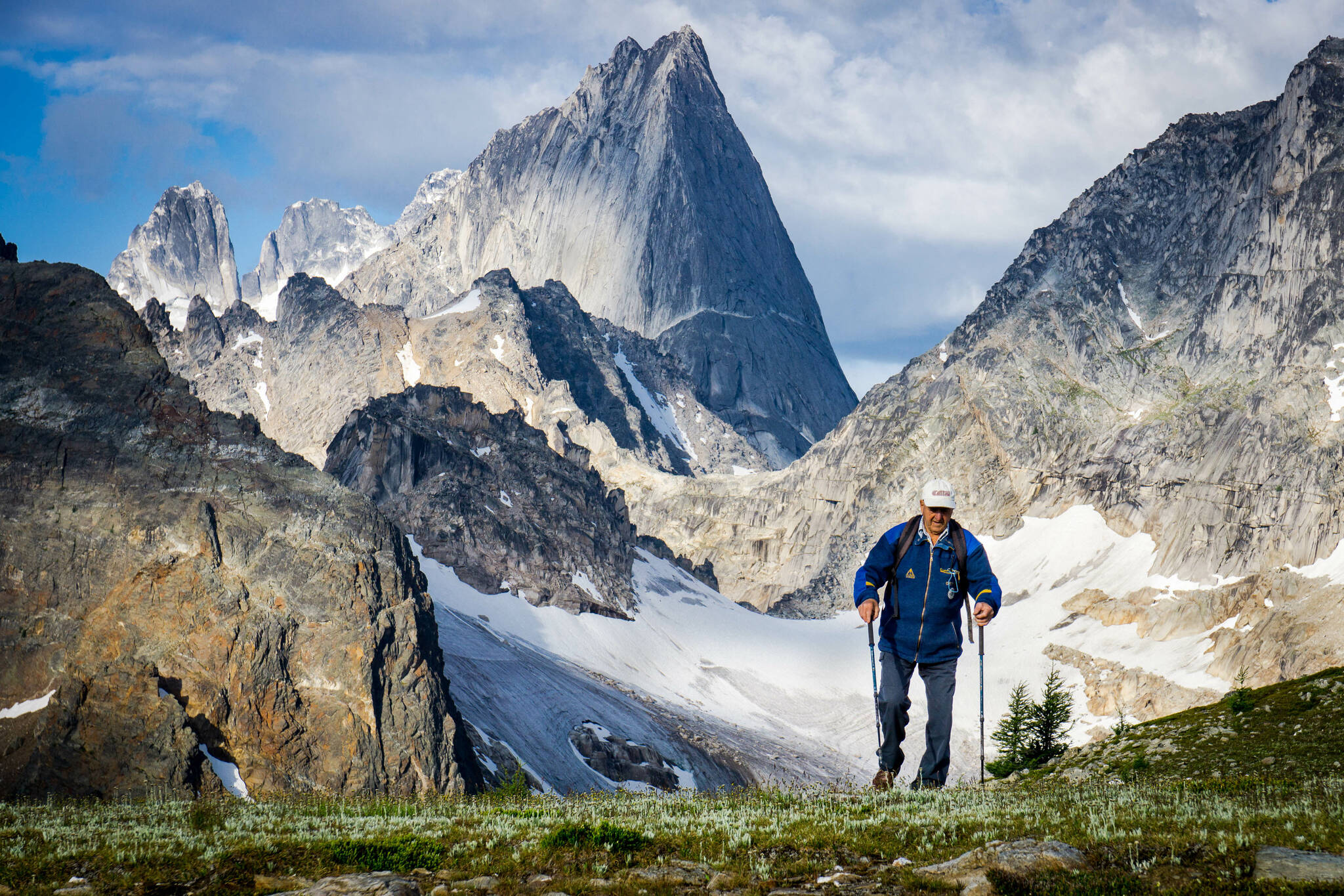 Leo Grillmair, guide, former manager of CMH Bugaboos Lodge, with Bugaboo Spire in background, Purcell Range, BC. (CMH Heli/Pat Morrow)