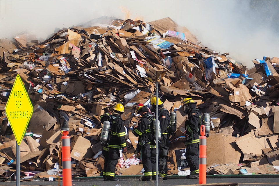 Firefighters battled a blaze that broke out in huge piles of recycling materials at a processing centre in south Nanaimo Tuesday, June 6, and were still on scene for much of Wednesday, June 7. (Chris Bush/News Bulletin)