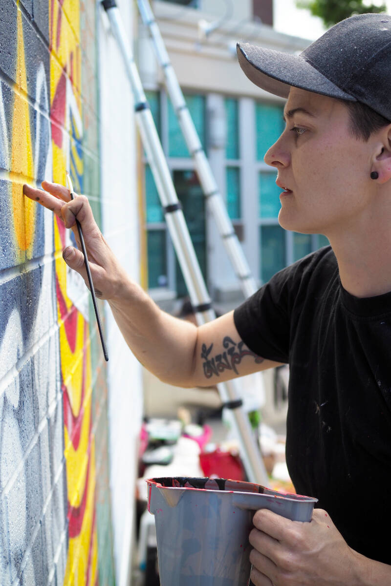 Nanaimo library wall turning into a brightly coloured bookshelf