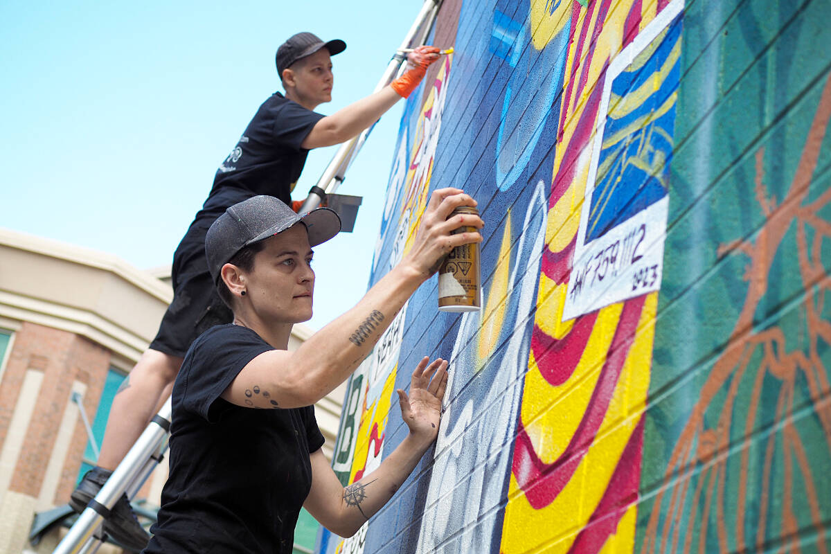 Nanaimo library wall turning into a brightly coloured bookshelf