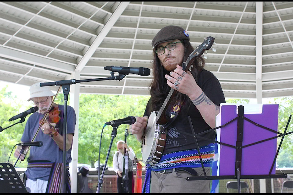 Kenney Chalifoux, a Cree-Métis musician, strums with the Coal Town Fiddlers during National Indigenous Peoples Day celebrations Friday, June 21, at Maffeo Sutton Park.