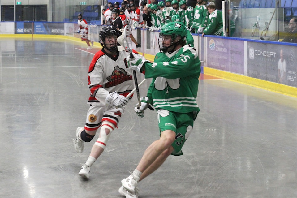 Nanaimo Timbermen player Andrew Bowman chases Victoria Shamrocks opponent Zach Sagodi during a B.C. Junior A Lacrosse League playoff game Saturday, July 26, at Frank Crane Arena. (Greg Sakaki/News Bulletin)