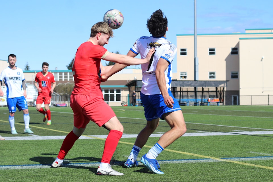 Nanaimo United player Ashton Bryant gets to a header before Evolution FC opponent Mateo Brazinha during a match Saturday, April 12, at Q'unq'inuqwstuxw Stadium. (Greg Sakaki/News Bulletin)