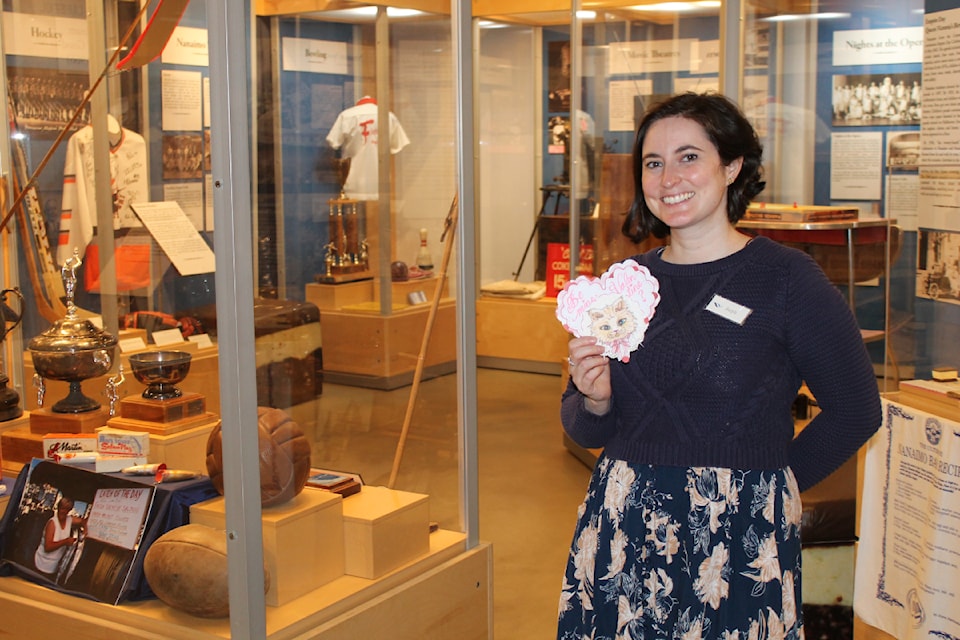 Steph Kveton, Nanaimo Museum program coordinator, holds a modern Valentine her co-worker made. (Jessica Durling/News Bulletin)