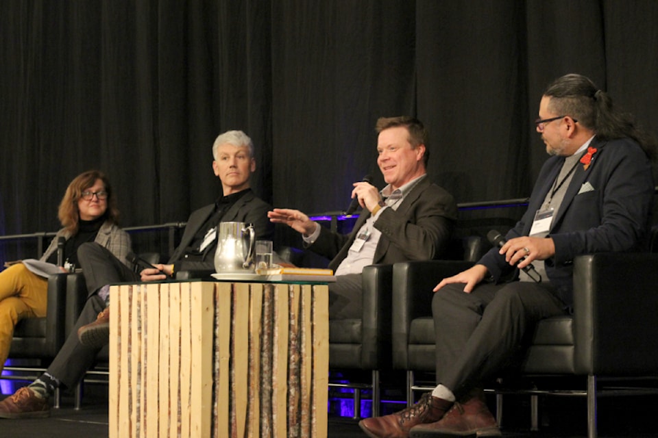 Susan Mowbray, partner with MNP's consulting group, speaks with Brodie Guy, CEO of the Island Coastal Economic Trust, Aaron Stone, CEO of the South Island Prosperity Partnership, and John Jack, chief councillor of Huu-ay-aht First Nations, on Wednesday, Oct. 23, at the Vancouver Island Economic Alliance summit at Nanaimo's Vancouver Island Conference Centre. (Greg Sakaki/News Bulletin)