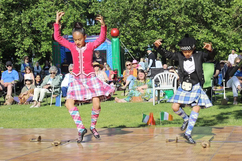 Isla and Patrick Garde, guest Highland dancers from Victoria, perform a sword dance as part of the What's the Craic? community event Wednesday, June 18, at Maffeo Sutton Park. (Greg Sakaki/News Bulletin)