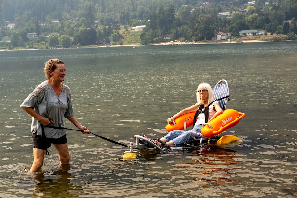 Janis Williams in her wheelchair in Kootenay Lake with caregiver Cathy-Jo Wright.