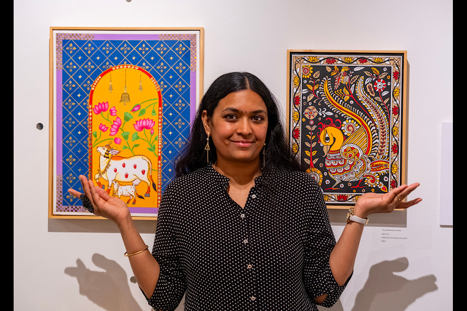 Surya Sameera Gonella of Nelson with two of her paintings representing different tribal cultural painting styles in India, as part of the Nelson museum show Within This Earthen Vessel, curated by Lucy Carver-Brennan. 