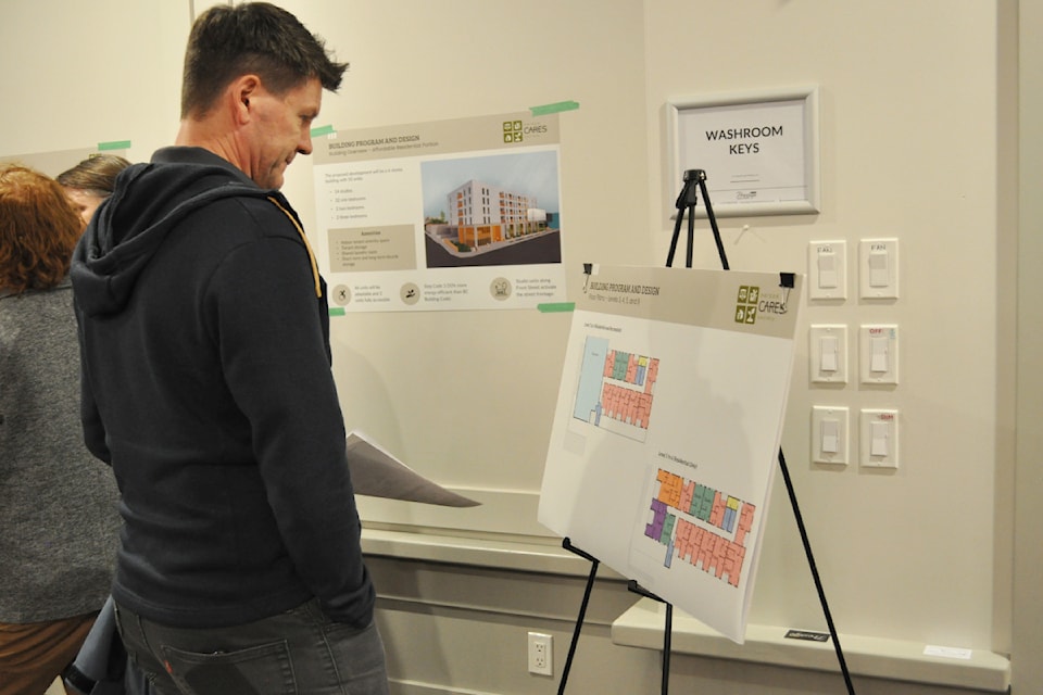 A Nelson resident looks over plans for a new six-storey affordable housing development during a Jan. 27 open house.