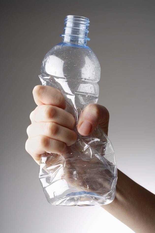 Hand squeezing water bottle