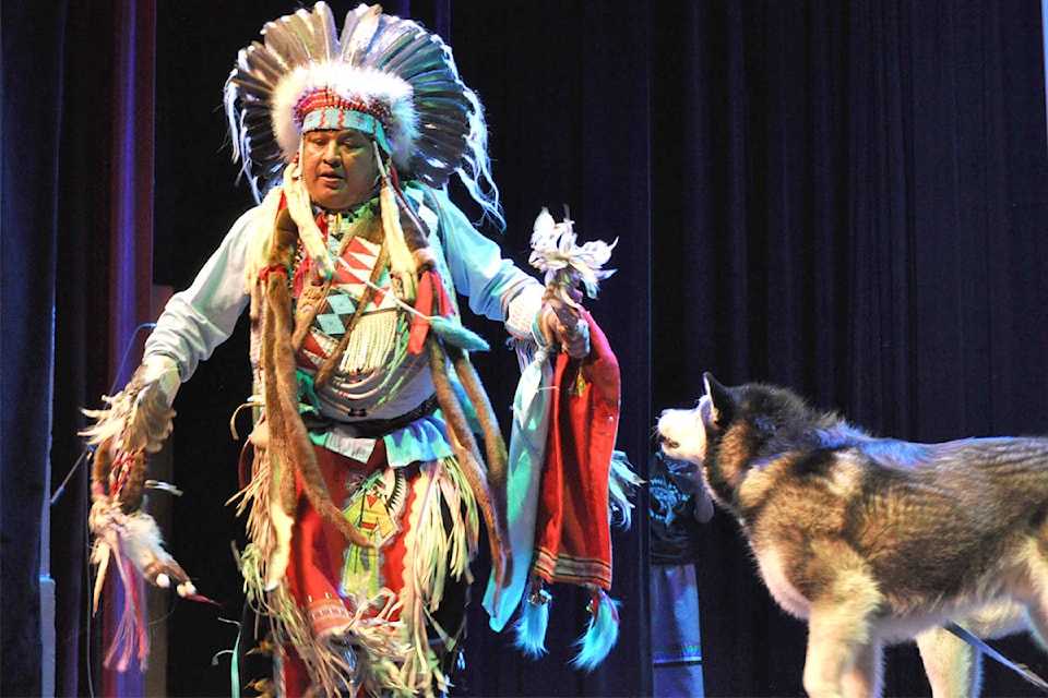Sinixt dancer Dan Nanamkim performs with an appearance from one of his two malamutes during the fifth annual Indigenous Culture Celebration on Friday at the Capitol Theatre. Photo: Tyler Harper