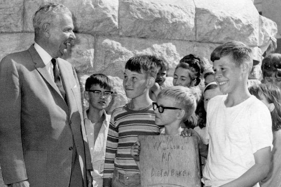 Prime Minister John Diefenbaker came to Nelson in July 1967 to receive the keys to the city. Here, Carl Golling and Robert Huth, ages 10 and 12, hold a sign welcoming Diefenbaker to Nelson. Photo: Nelson Daily News Collection