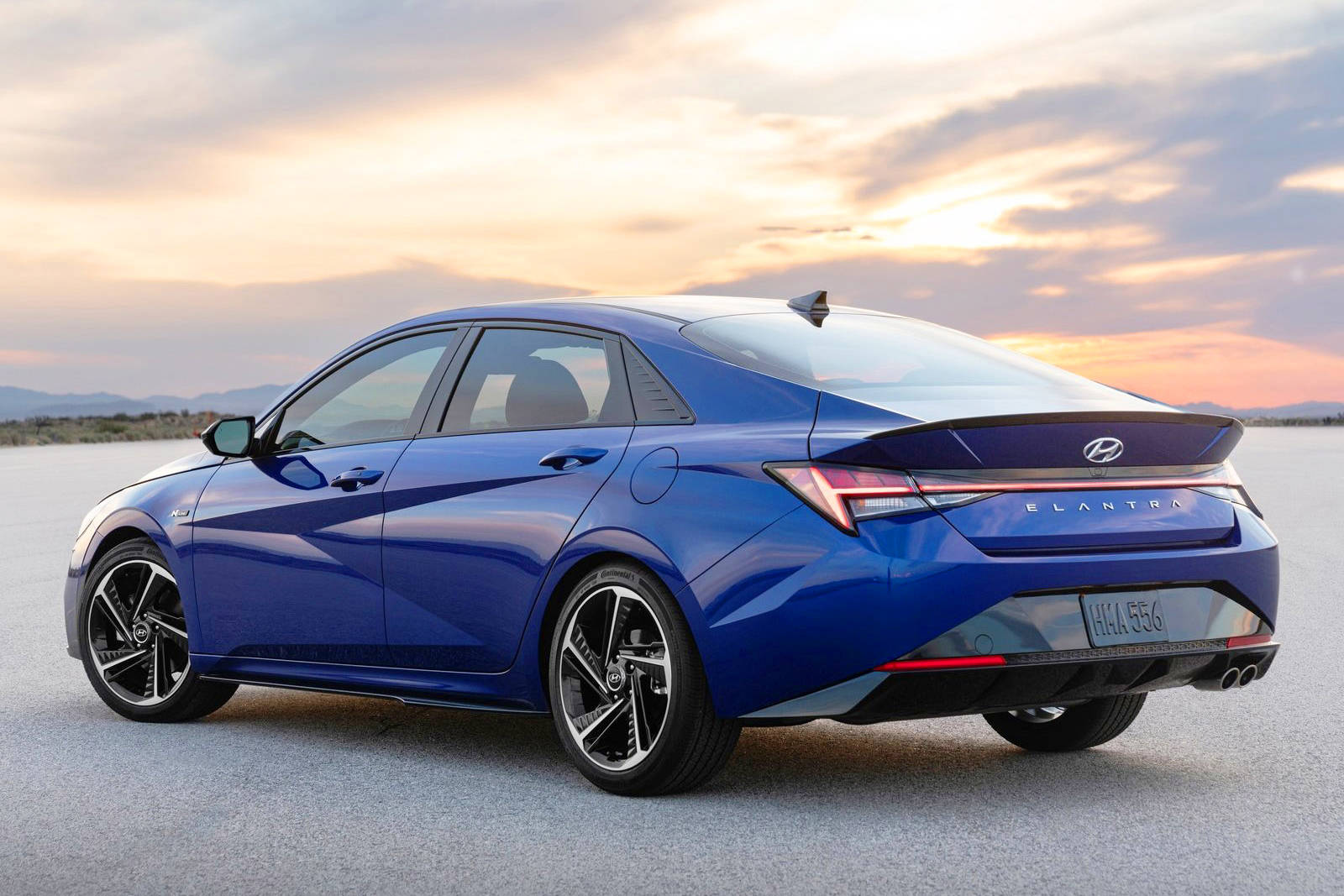 The 2021 Hyundai Elantra features attractive side creases extending along the door and rear-fender panels that blend into a knife-edged trunk lid.