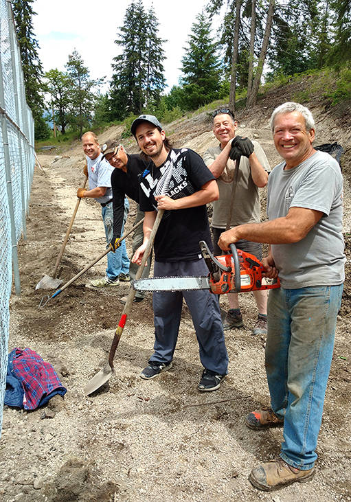 Rob Wright, seen here holding a chainsaw along with Nelson Tennis Club members, was key to the construction of new courts near L.V. Rogers. Photo: Submitted