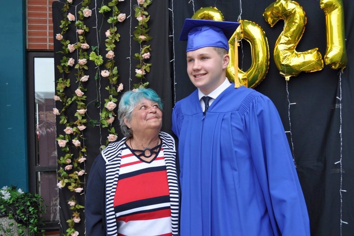Graduate Michael Rhodes-Bliss shares a moment with his grandmother. Photo: Tyler Harper