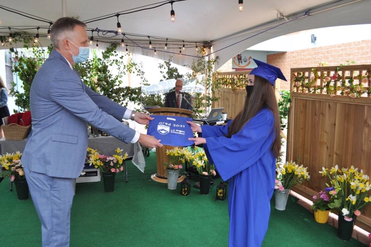 Amy Schellenberg accepts her diploma from principal Ben Eaton. Photo: Tyler Harper