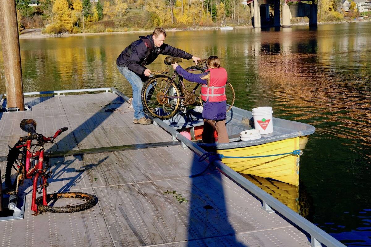 Friends of Kootenay Lake volunteers Mike Sagal and Tara Lyons unloading trash found by divers in Kootenay Lake. Photo: Bill Metcalfe