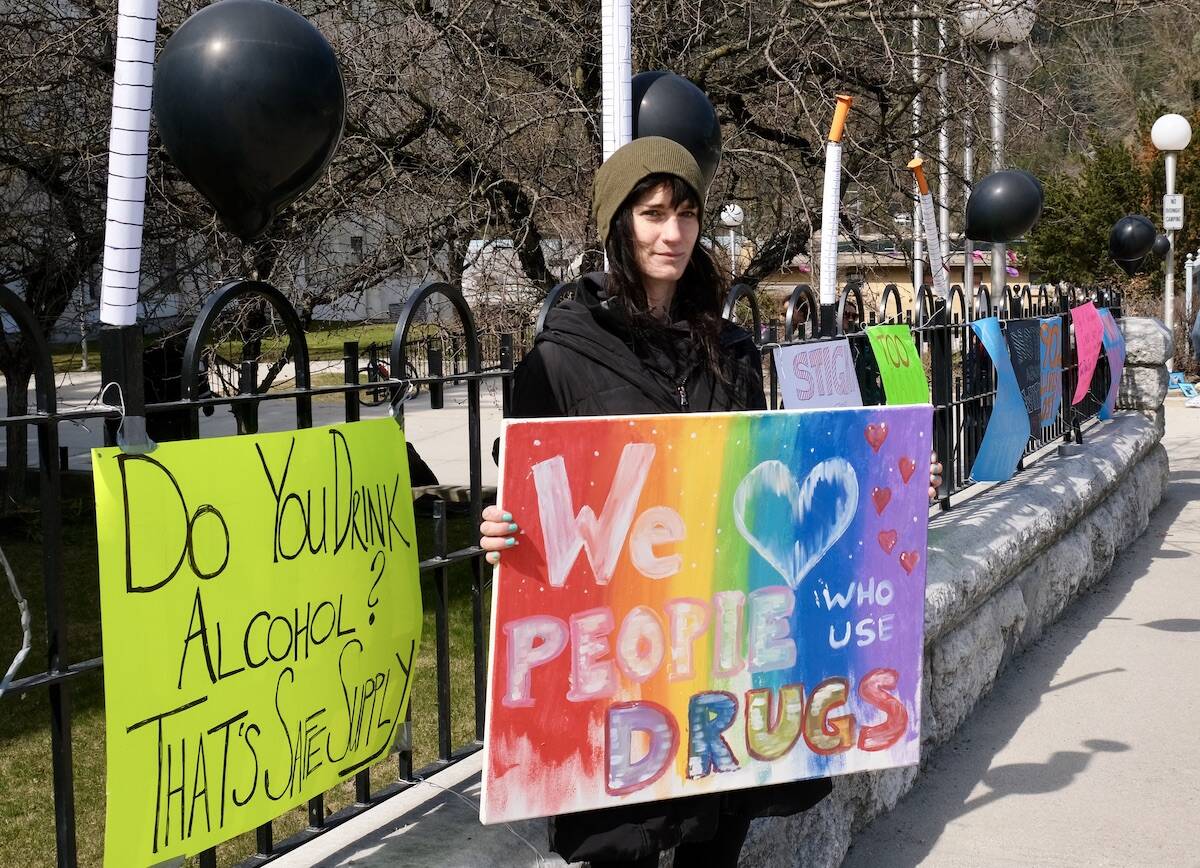 Holly Trider of ANKORS at the April 14 demonstration in Nelson calling for decriminalization and safe drug supply. Black balloons have become a symbol of deaths caused by toxic drug poisoning. Photo: Bill Metcalfe
