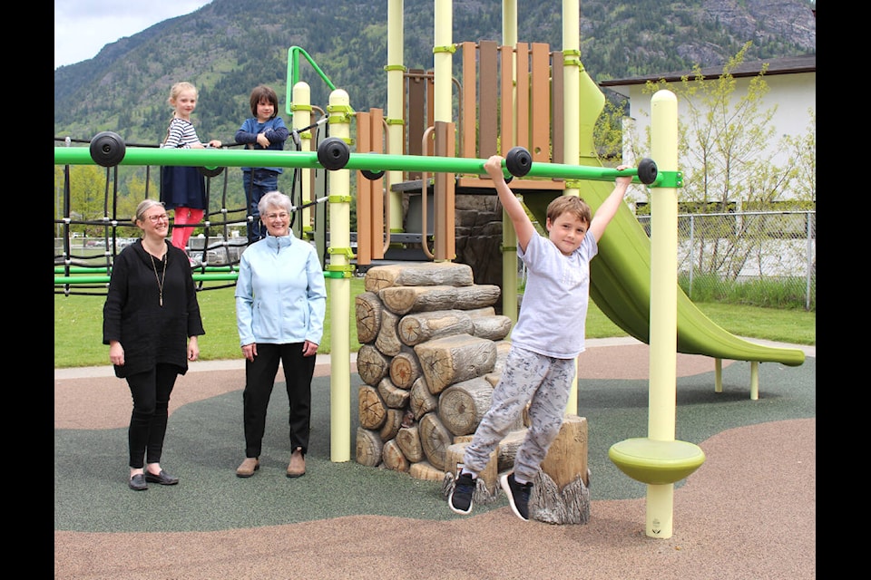 School District 20 superintendent Katherine Shearer (L) joined Kootenay West MLA Katrine Conroy to observe school children enjoying the playground at Twin Rivers/Castlegar Primary School on May 27. Photo: Betsy Kline