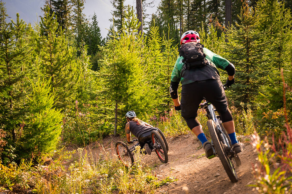 Adaptive mountain bike trails need to be slightly wider to accomodate three or four wheels, but they definitely dont need to be flat. Taking turns on the Spine Trail in Roseberry, BC. Photo courtesy Kootenay Adaptive Sport Association/Jesse Schpakowski.