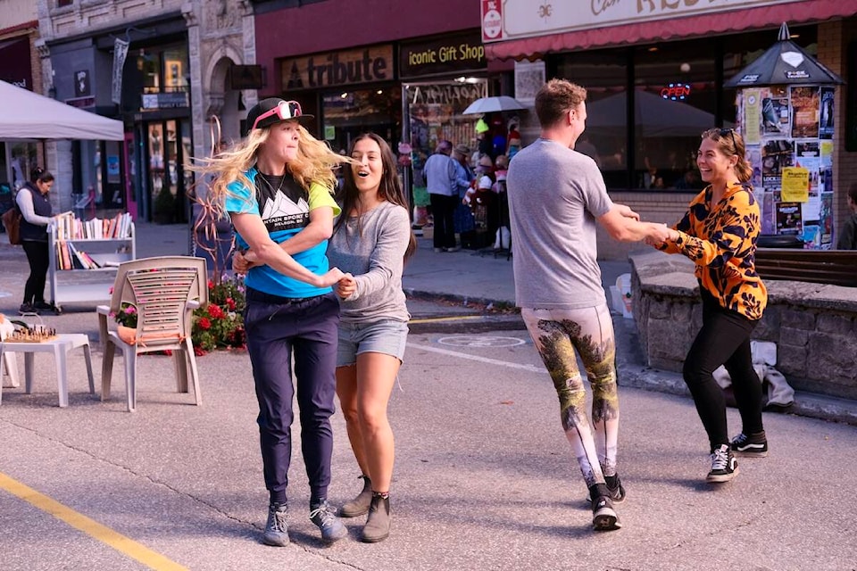 Nelson residents enjoy a pop-up town square on a block of Baker Street, which was closed to traffic Sunday. Photo: Bill Metcalfe