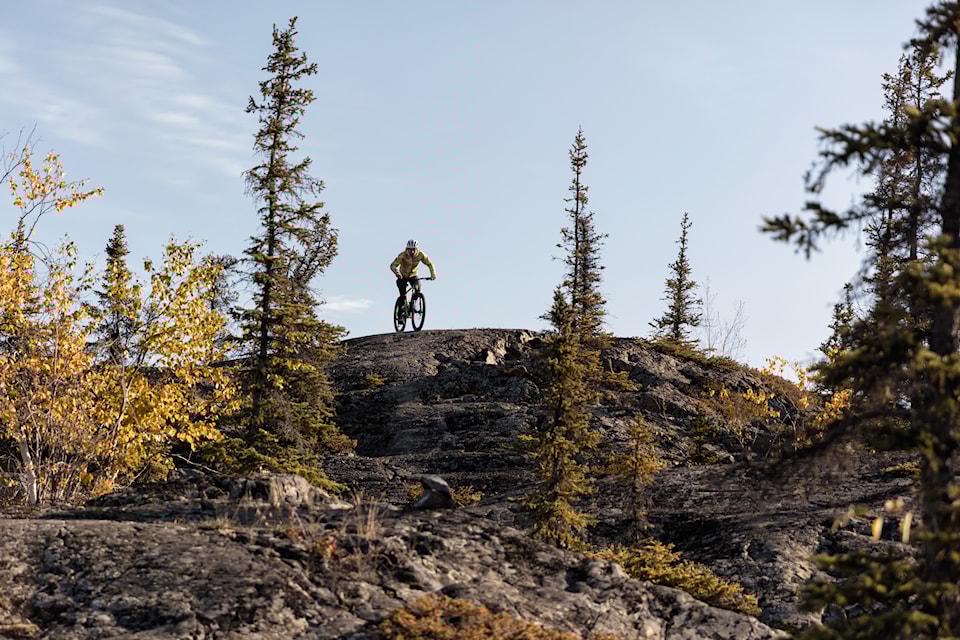 A participant of Cycling NWT's new coaching courses sits atop a hill. Six prospective coaches participated in the courses. Photo courtesy of Thorsten Gohl