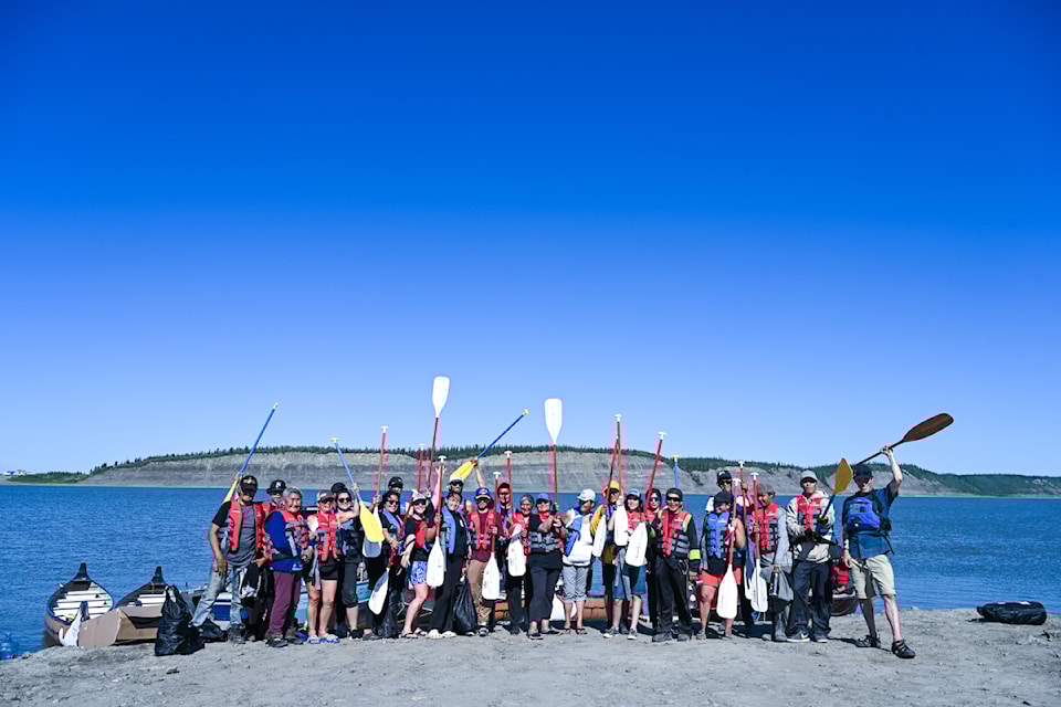 Paddle are held high as the team of canoeists prepare to set out from Tsiigehtchic. Following the waterways used by their ancestors to navigate the North for time immemorial, a team of Gwich'in voyageurs took a week-long canoe trip from Tsiigehtchic to the Gwich'in Wellness Camp from Aug. 2 to 7.
