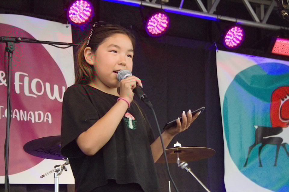 Our Youth of the Week is Olivia Pokiak, seen here singing lyrics from her phone during the Deadly in the Delta talent show as part of the Fiddle 'n Flow music festival earlier this year. Olivia was one of several youth to brave the stage and put their talents on display in front of an audience.