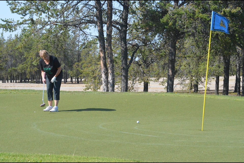 Deanna Bryan watches her putt roll toward the hole at the 14th. James McCarthy/NNSL photo