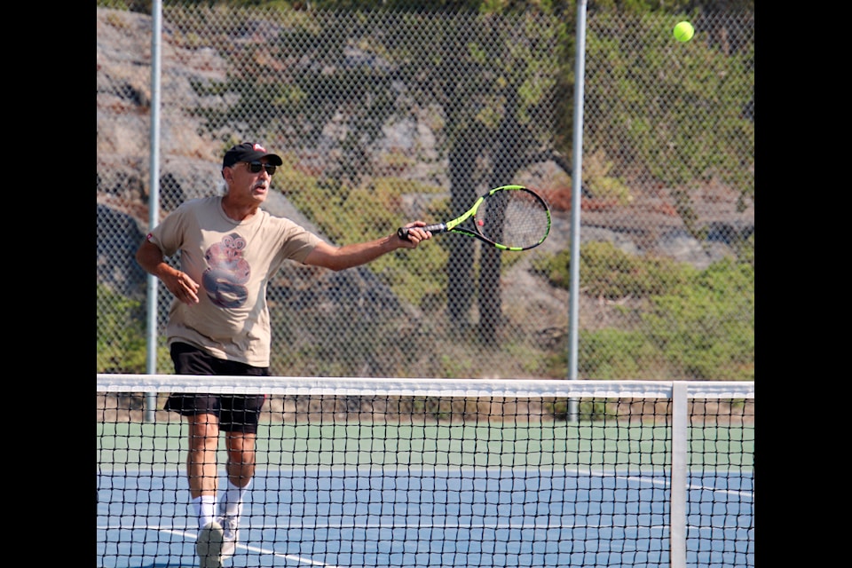 Veteran player Dennis Bevington  makes a return shot during the weekend tournament. Jill Westerman/ϳԹ photo  