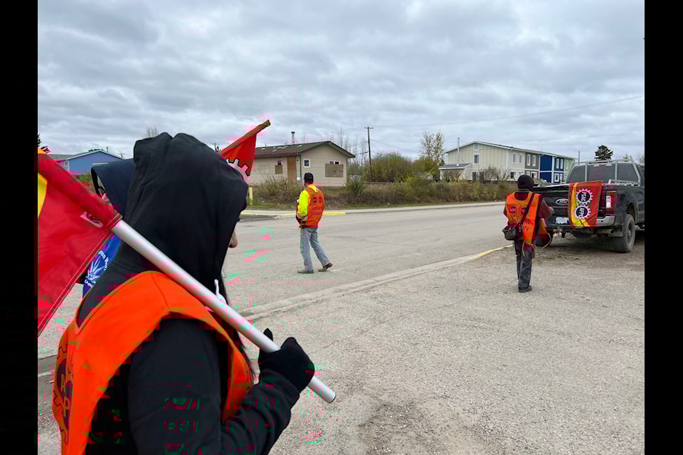 Striking employees of the Fort Simpson Housing Authority carry flags on the picket line in the community of about 1,100 people.
Photo courtesy of Public Service Alliance of Canada