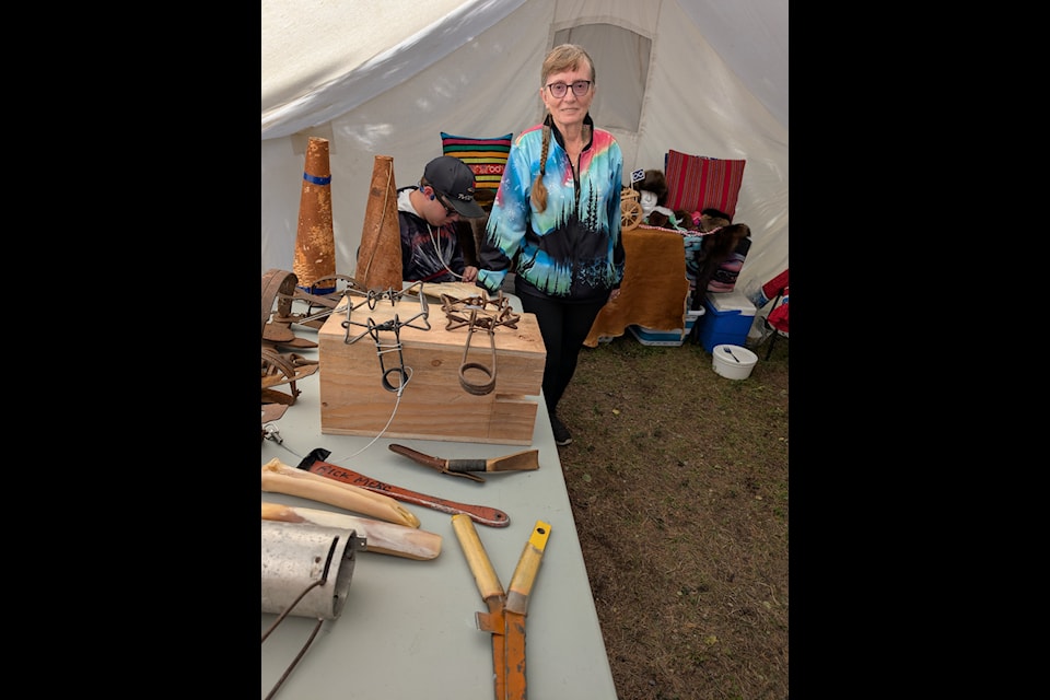 Barb Mercredi shows some of the artifacts on display in the Metis exhibit. Photo courtesy of Nancy Vail