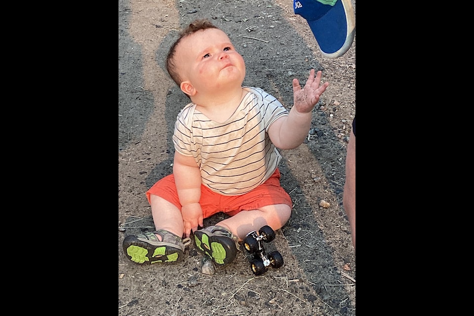 Baby Gordon McCord watches dad, Ryan, a musician, perform on stage. Nancy Vail/NNSL photo