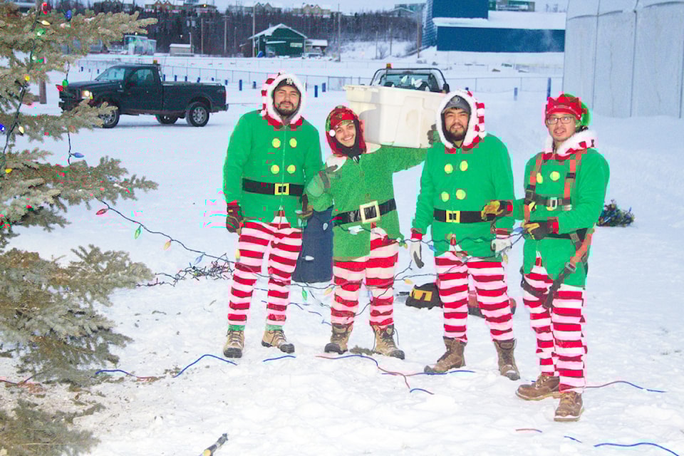 Christmas elves Justin Kunnizzie, Mikey Cardinal, Austin Van Loon and Randy Inglangasuk dress the Town of Inuvik's Christmas tree as the town makes its preparations for the holidays. The initiative was a joint effort between the town, Inuvik Construction and Northwind Industries... and the North Pole, of course.