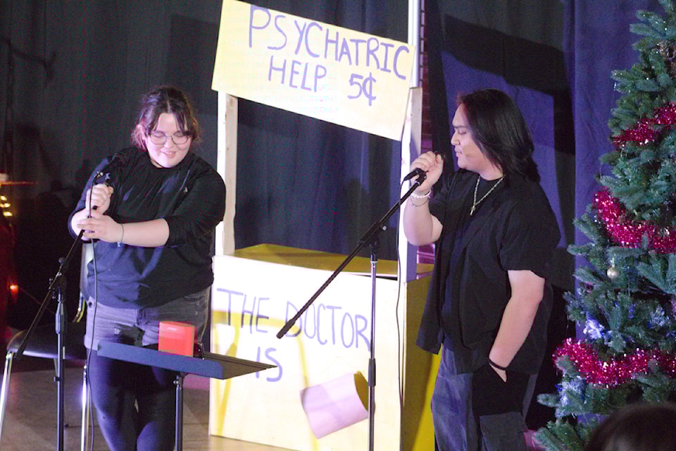 Our Youths of the Week are Ella Tingmiak and Kurt Loman, seen here singing 'Home' for a joyful crowd over the holidays. Kurt emceed the East Three School Christmas Coffee House while Ella provided tech and backstage support.