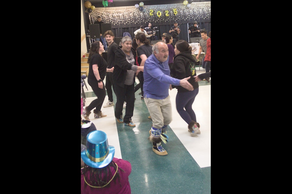 Save the last dance for me. Brian Rogers reaches out during a line dance at the Inuvik Community Events Society's New Year's Eve feast and dance. The community brought in 2025 doing what Inuvik does best: dancing and feasting.