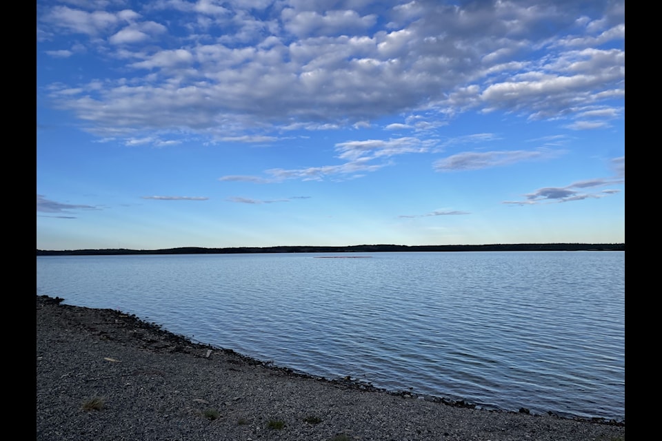 The area around the sunken boat has been cordoned off with an orange perimeter, faintly visible in the waters above, and a buoy in the middle. The site can be seen from the boat launch by the Yellowknife Historical Museum.