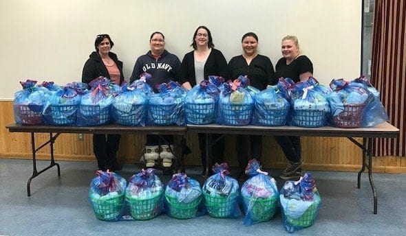 Jody Pellissey, Renee Sanderson, Lindsey Dwojak, Cheryl Mandeville and Caitlin Cleveland assemble baby baskets for mothers in need. In April the group delivered 35 baby baskets to the hospital in April, a project Renee organizes every six months through Pay It Forward NWT. Photo courtesy of Renee Sanderson. 