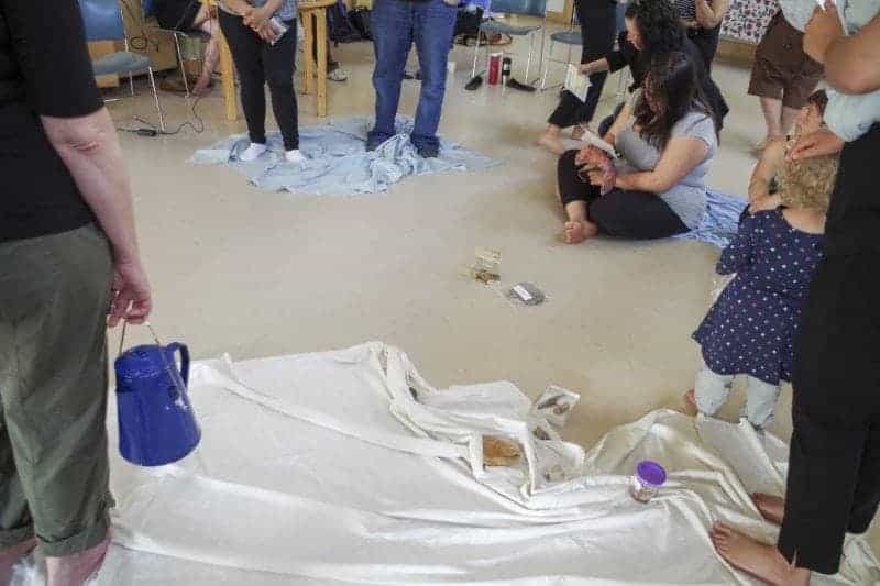 Mishelle Lavoie reads from a card as other participants listen, confined to their blankets of "land" that grow smaller and smaller as the exercise progresses. Lavoie and 24 others took part in the Blanket Exercise, an interactive learning experience on Canadian colonial history, on May 31 at the Baker Community Center in Yellowknife. Emelie Peacock/NNSL Photo