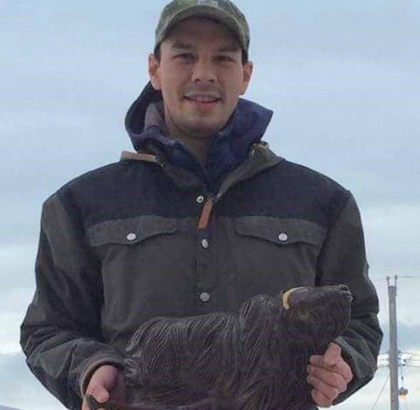 Damien Ikuallaq displays one of his detailed muskox carvings. He has been creating art in Cambridge Bay for the past 10 years and is looking at options for opening a studio there. photo courtesy of Damien Ikuallaq