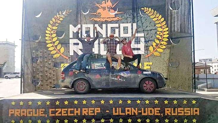 Team Grizzly Rims – left to right, Barrett Gibb from Hay River, Jackson Weibe and Jamie Dainton – celebrate after reaching the finish line of the Mongol Rally in Ulan-Ude, Russia. Photo courtesy of Barrett Gibb