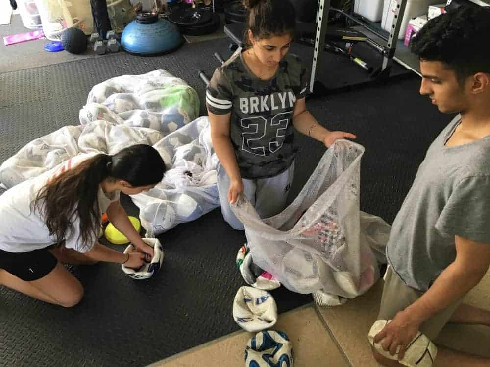 Sports for Smiles members Janeva Shahi, left, Kanaka Shahi and Deva Shahi pack up their donation to the Inuvik Youth Centre. Photo courtesy of Janeva Shahi