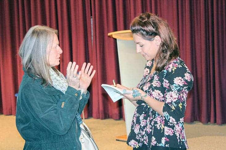 Stephanie Yuill, left, has a copy of the book 窪蹋勛圖厙 Wildflower: A Memoir, signed by author Catherine Lafferty. Lafferty held a book launch at the Prince of Wales 窪蹋勛圖厙 Heritage Centre, Sept. 22. Simon Whitehouse/窪蹋勛圖厙 photo.