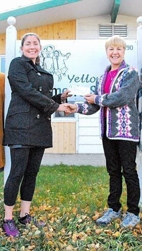 Bree Denning, left, accepts a cheque for $22,500 from Trina Rentmeister in front of the Yellowknife Women's Society this past Tuesday. The money was raised from the Adlair Aviation/Ryfan Electric Women's Charity Golf Tournament at the Yellowknife Golf Club last month and will be put toward the Housing First program. James McCarthy/NNSL photo.